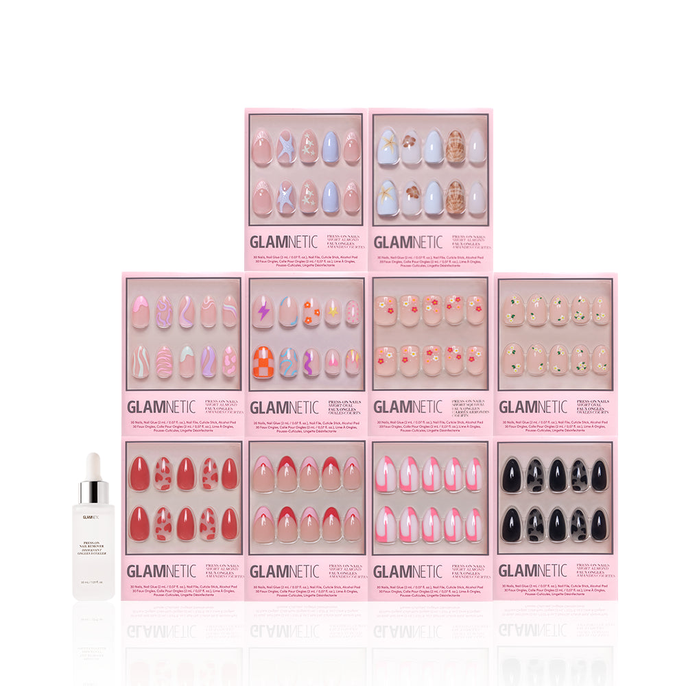 Ten boxes of glamnetic's Trendy Not Spendy press-on nails in pink, red, and nude short almond sets are arranged in a pyramid, with a nail glue bottle in front, all on a white background. - Product image