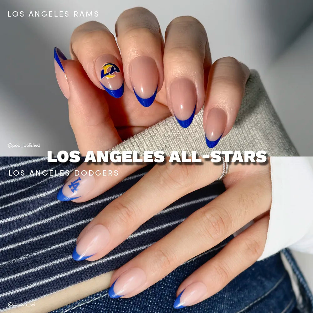 Show off your glamnetic Los Angeles All-Stars nails: nude base with blue tips, featuring officially licensed Rams and Dodgers logos—a must-have mani for LA sports fans! Striped shirt and gray sleeve complete the look.