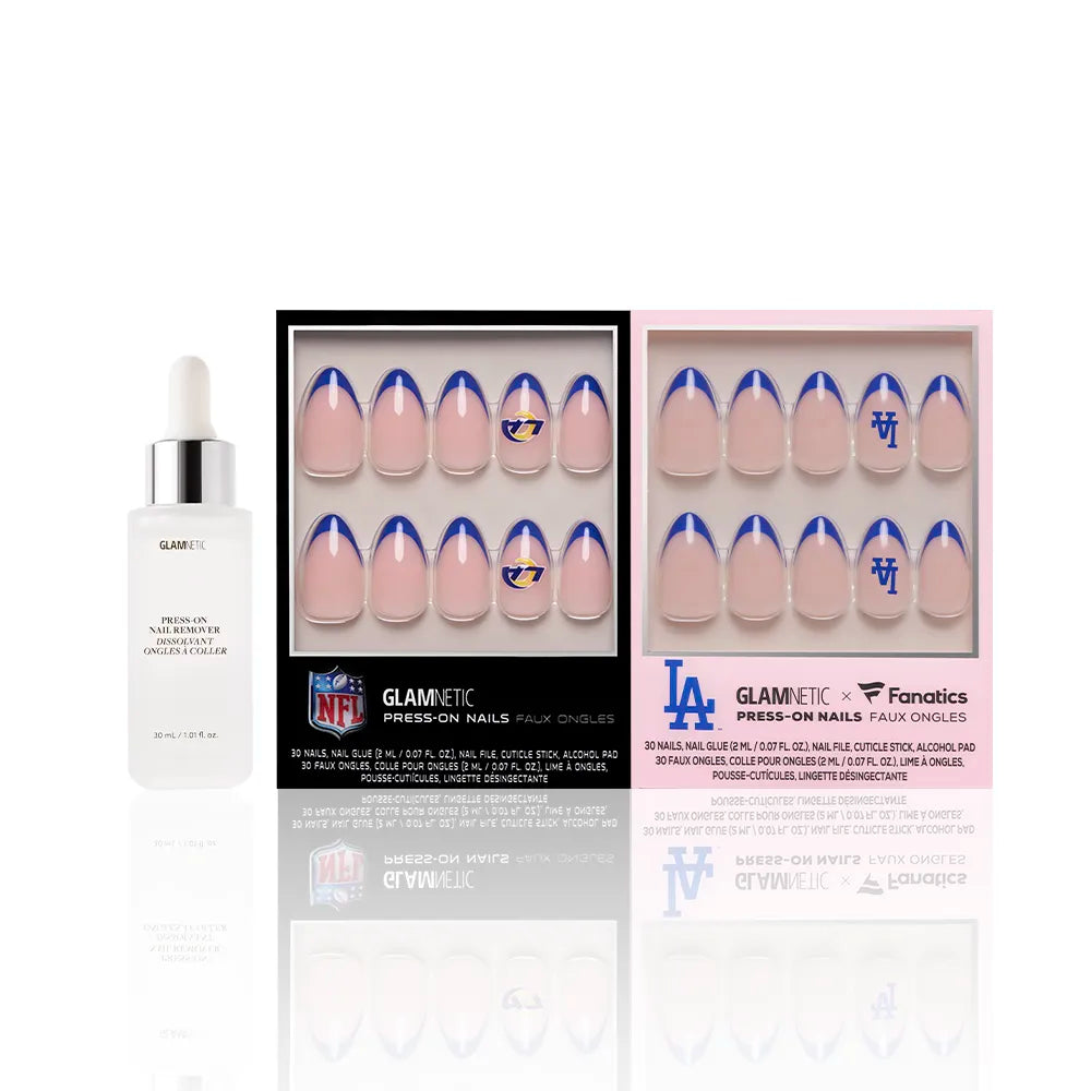 The glamnetic Los Angeles All-Stars bundle, featuring a bottle of cuticle oil and two press-on nail sets with pink nails and blue-and-gold team logos, is displayed in sleek black and pink packaging on a reflective white background. - Product image