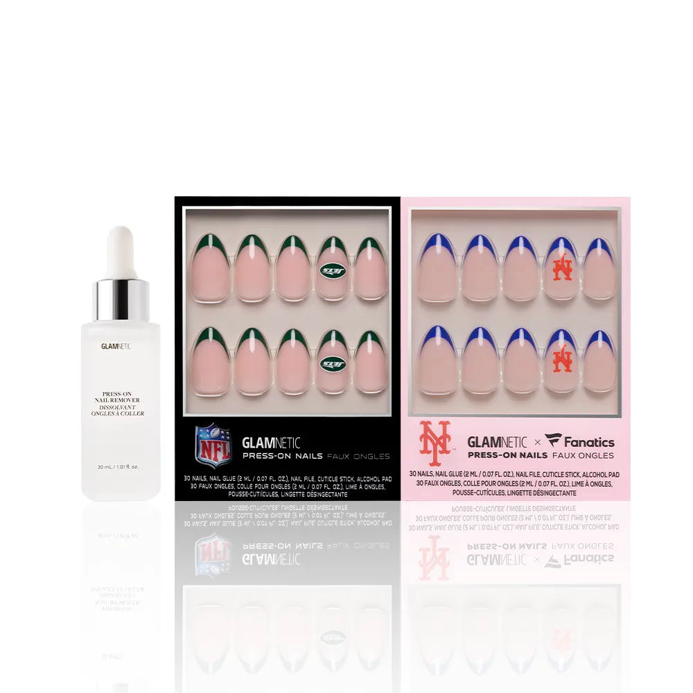A bottle of glamnetic cuticle oil sits next to two boxes of officially licensed glamnetic press-on nail sets, including the New York All-Stars Jets & Mets bundle, all arranged in a clean, white setting. - Product image