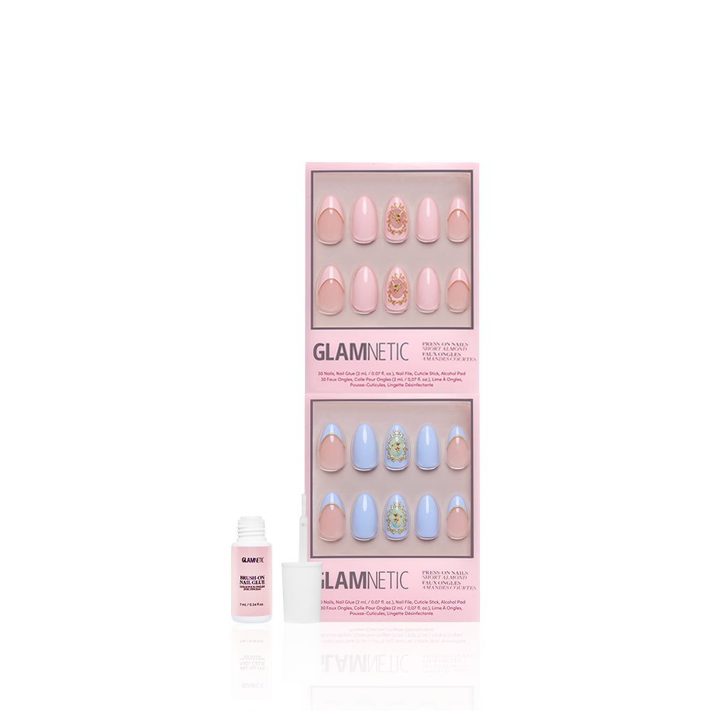 A boxed set of glamnetic Heaven Sent almond press-on nails in pastel pink and blue, featuring 3D gold accent details. An open bottle of nail glue is placed in front of the package. - Product image