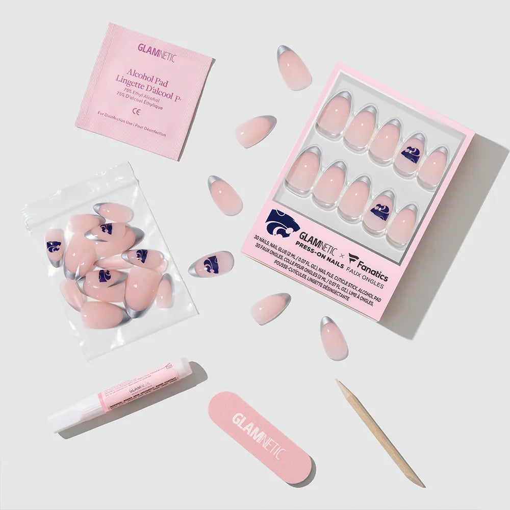 The glamnetic Kansas State Wildcats Press-On Nail Set features pink nails with purple tips, plus an alcohol pad, nail glue tube, mini nail file, wooden cuticle stick, and extra nails—arranged on a light background. - Product image