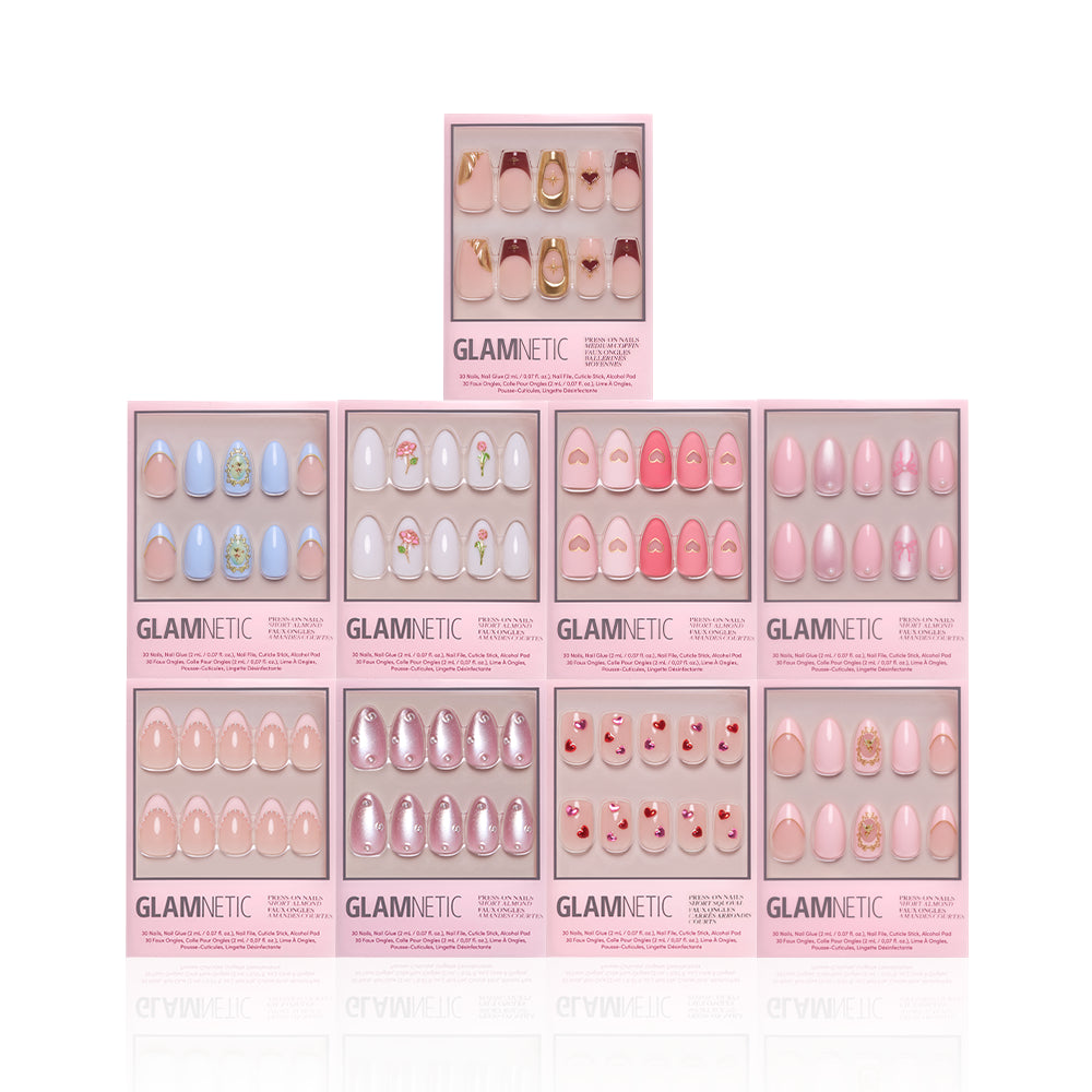 Ten boxes of glamnetic Love in 3D press-on nails, featuring assorted pink and pastel designs with 3D art and almond styles, are stacked pyramid-style on a white background. Each pink box highlights different unique nail art options. - Product image