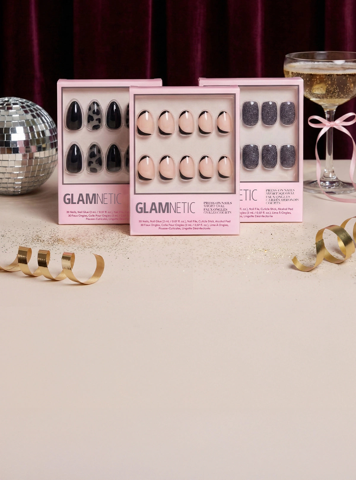 Glamnetic nail art sets with decorative items on a neutral background