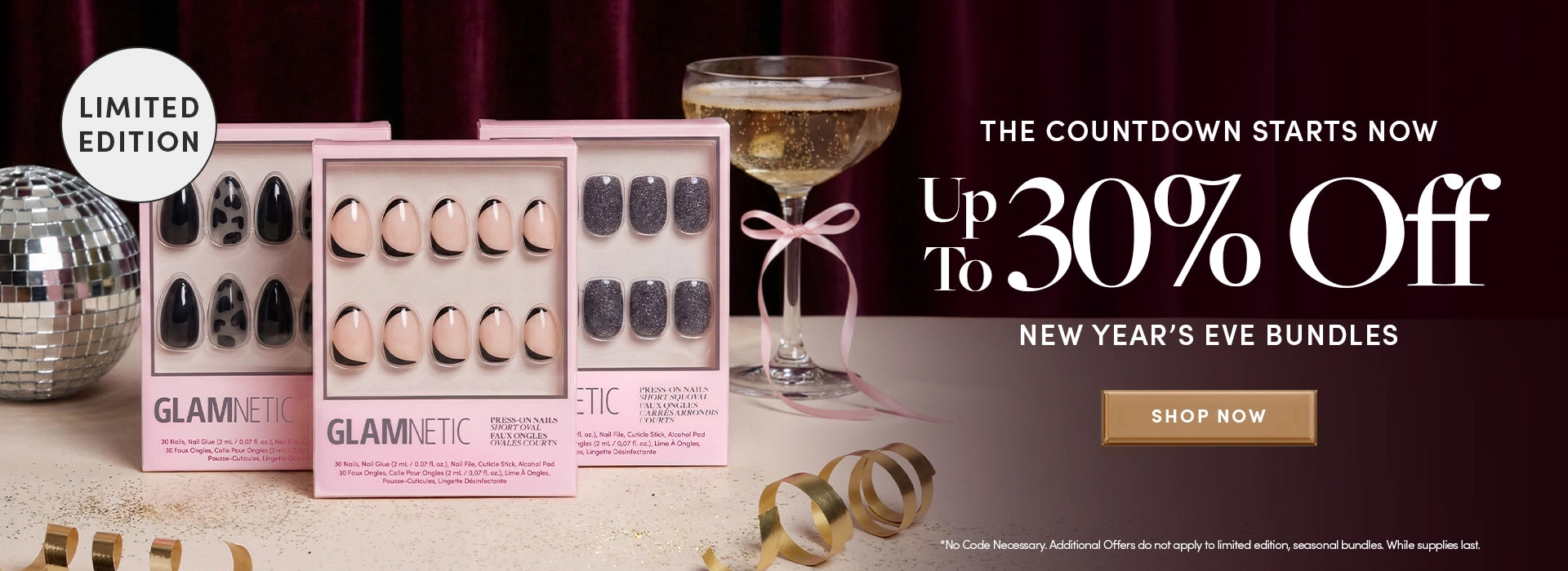 Glamnetic magnetic nail art sets with a New Year's Eve theme, including a glass of champagne and decorative ribbons.1