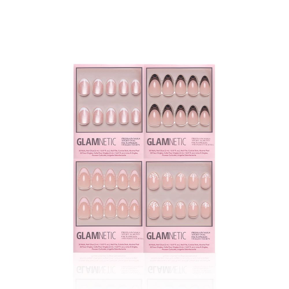 A set of four Glamnetic "The French Kiss" press-on nail boxes featuring modern nude and pink designs—plain, French tip, and white floral—displayed against a white background. - Product image