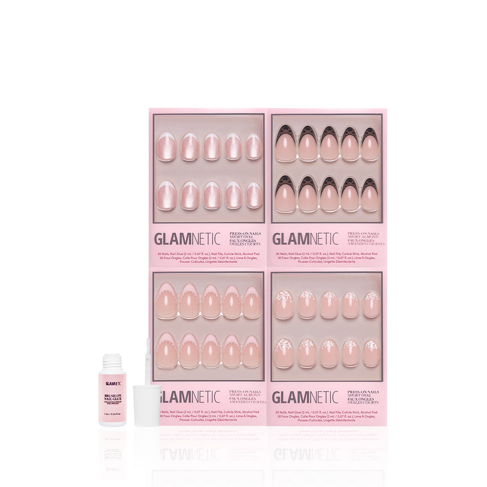 Four pink boxes of glamnetic’s "The French Kiss" press-on nails, featuring modern almond and French tip designs, are arranged in a grid. An open nail glue bottle with a white cap sits in front on a white background. - Product image