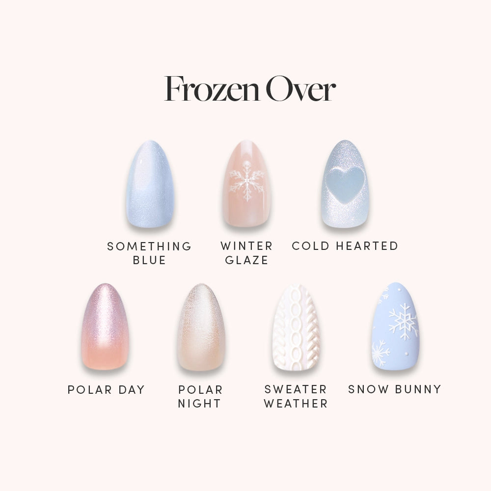 Frozen Over by glamnetic: a set of seven short almond artificial nails with winter designs featuring blue, white, pearlescent shades, snowflakes, a heart, and knit sweater pattern. Each nail has a unique winter-inspired name.
