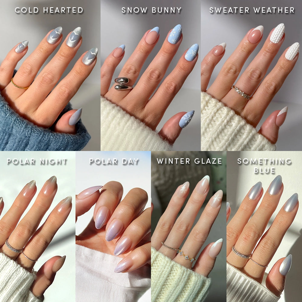 A collage of eight manicured hands, each showing a unique winter nail design on short almond nails in blue, white, and silver. The Frozen Over set by glamnetic features seasonal details like snowflakes for chilly inspiration.