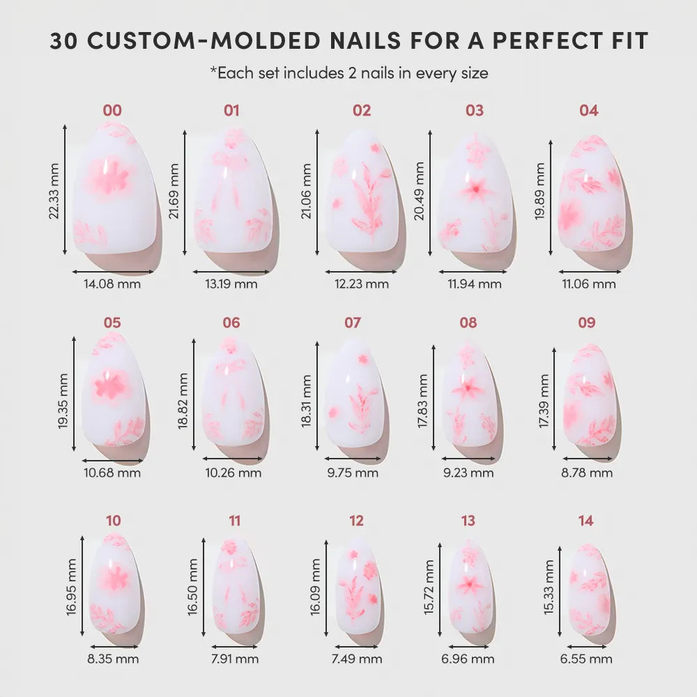 The Fleur Amour set by glamnetic features a chart of 15 vegan, cruelty-free pink blossom nails with floral designs on a light base. Width and length in millimeters are shown for each size to ensure the perfect fit. - Product image