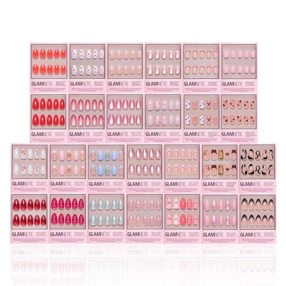 The glamnetic Love Notes Collection features 20 press-on nail kits in pink packaging, with almond and coffin shapes in pink, nude, red shades, plus playful patterns or faces, all neatly arranged in rows. - Product image