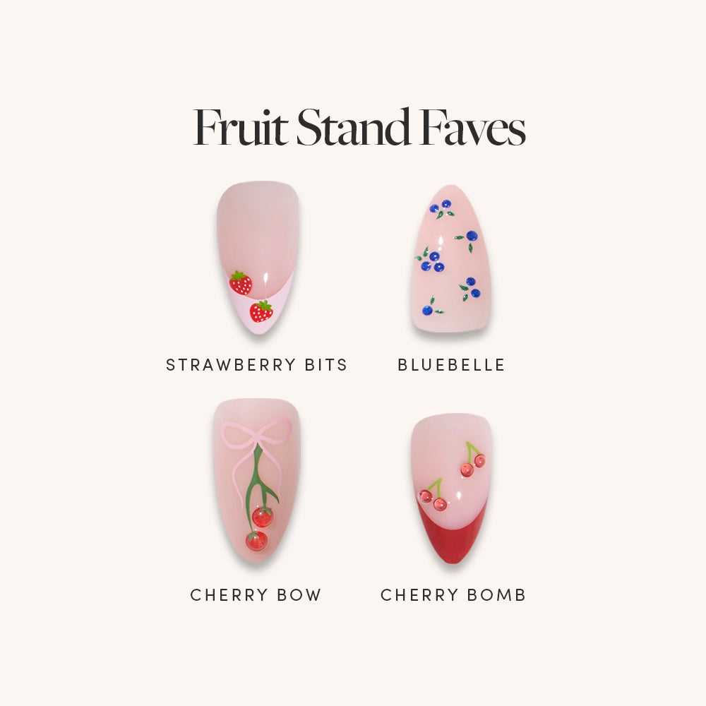 The glamnetic Fruit Stand Faves set features four nail art designs: Strawberry Bits with berry accents, Bluebelle with blue flowers, Cherry Bomb with cherries and a bow, and Cherry Bow with cherries and bold French tips.