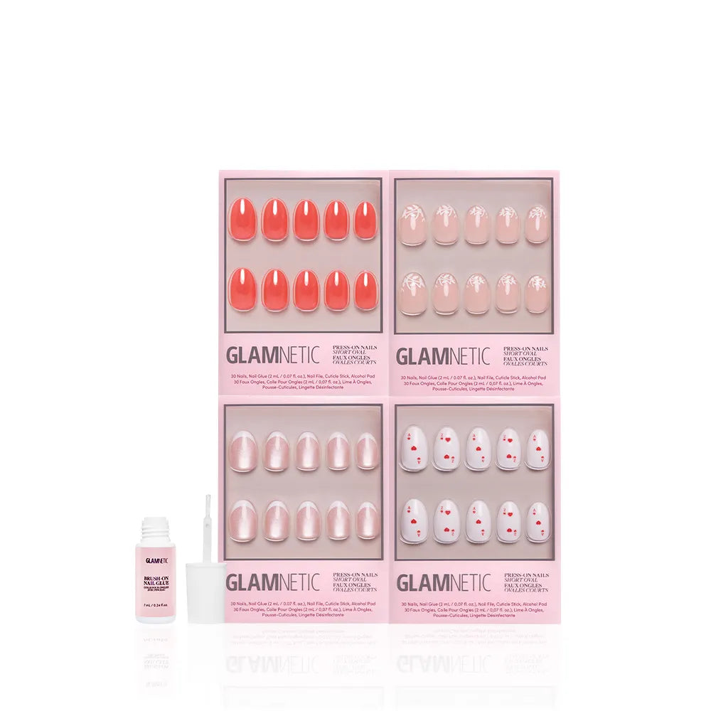 Four sets of glamnetic's The Oval Affair press-on nails in pink packaging showcase soft-luxury, classic oval designs in pink and coral. A nail glue with brush sits on the left, all on a white background. - Product image