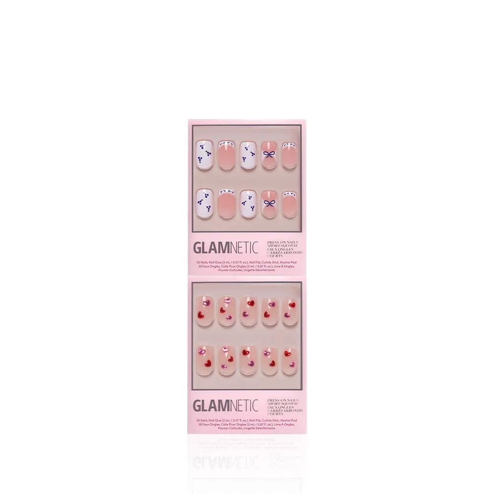 Two sets of glamnetic press-on nails in pink packaging: The Sweet Squovals set with purple and white squoval designs on top, and a cute pink set with small red cherry accents below. Both sets are displayed vertically. - Product image