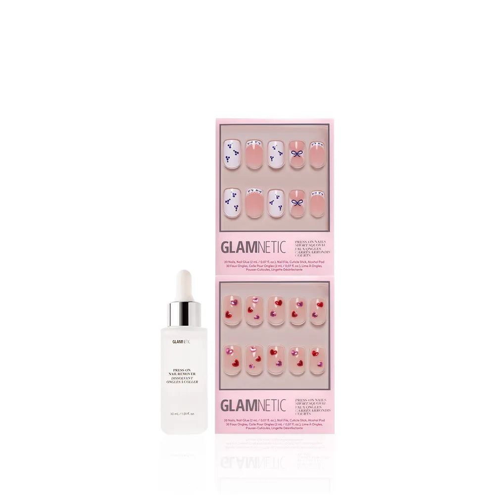 A bottle of Glamnetic cuticle oil with dropper sits beside The Sweet Squovals by glamnetic—press-on nails in pink packaging, featuring blue and red flower designs or red hearts on nude, perfect for everyday glam. - Product image