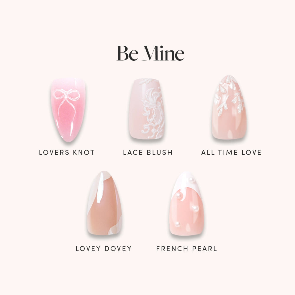 Glamnetic Be Mine features five almond nail designs: Lovers Knot (pink/white bow), Lace Blush (light pink/lace), All Time Love (nude/white hearts), Lovey Dovey (nude French tip), and French Pearl (pink/pearls). - Product image