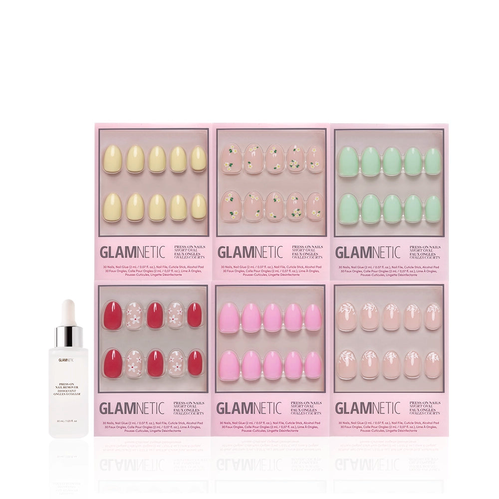 Six sets of glamnetic Oval Petals & Polish press-on nails, in pastel shades and floral designs, are shown in pink boxes above a glamnetic cuticle oil bottle with dropper. Each set offers unique colors and styles. - Product image