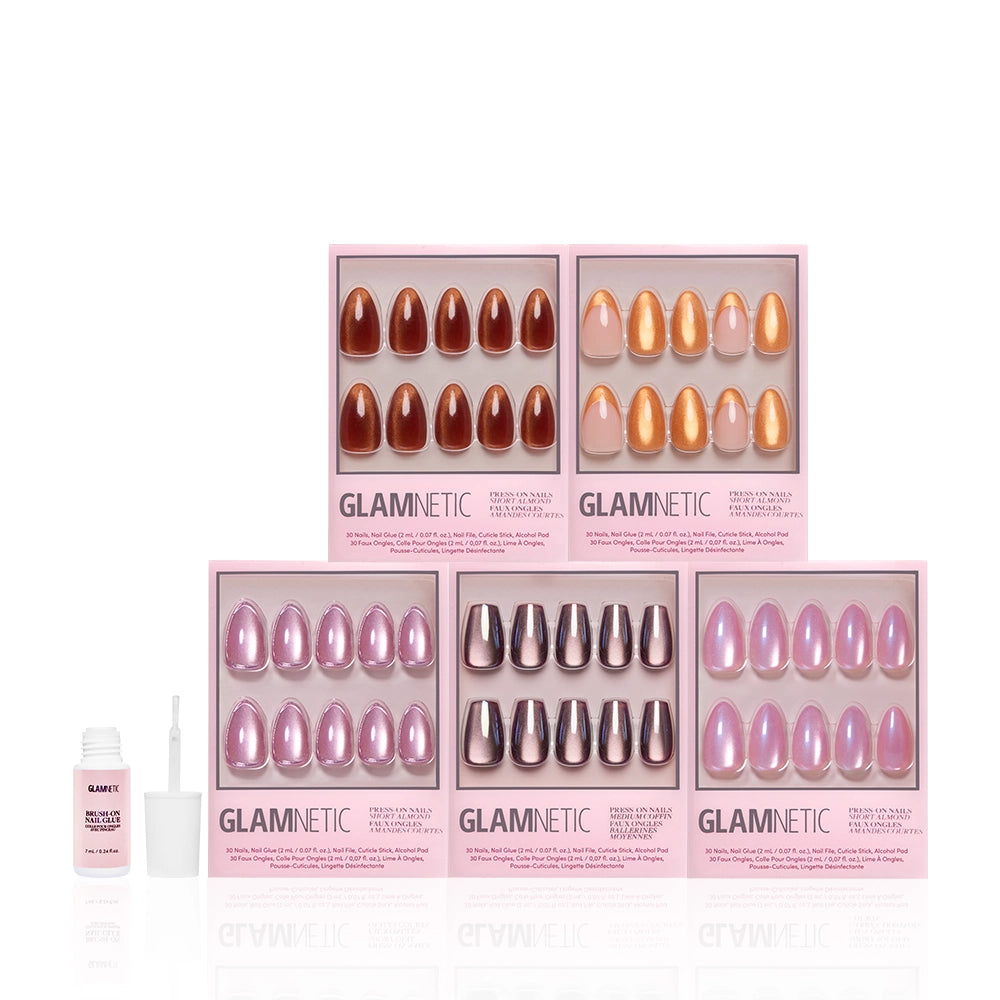 Six boxes of glamnetic Golden Hour press-on nails in brown, pink, peach, and metallic shades with multi-dimensional shimmer are arranged in two rows. A small bottle of glamnetic nail glue with brush is on the left against a white background. - Product image