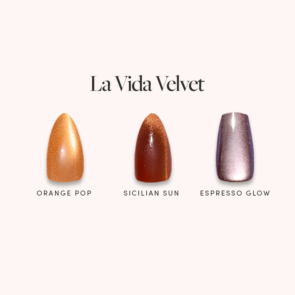 Under the “La Vida Velvet” collection by glamnetic, three nail polish swatches—Orange Pop (shimmery orange), Sicilian Sun (shimmery bronze), and Espresso Glow (metallic mauve)—highlight multi-dimensional shimmer ideal for velvet press-ons.