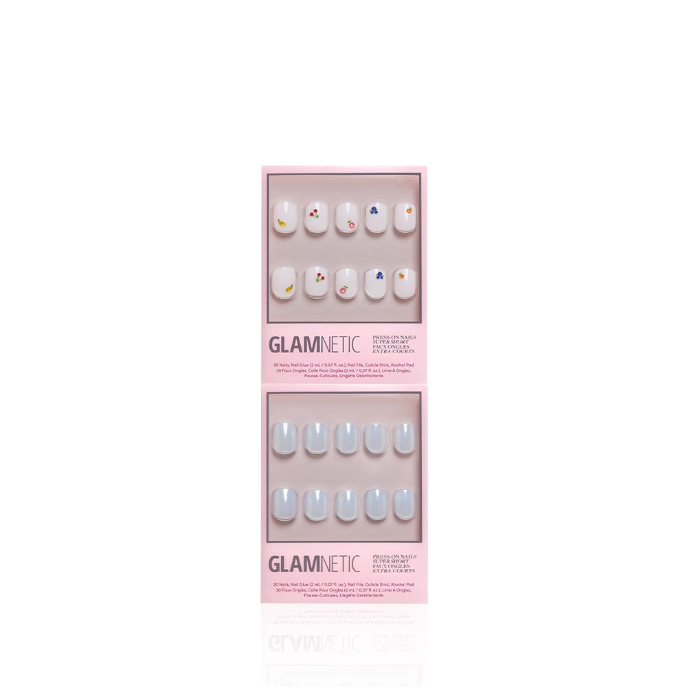 Two sets of glamnetic "Short & Suite" press-on nails in pink boxes: the top has short white nails with colorful flowers, while the bottom shows solid light blue nails, both displayed against a white background. - Product image