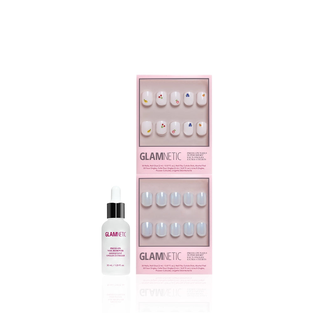 Two sets of glamnetic Short & Suite salon-quality press-on nails—one playful, one simple—in pink boxes are displayed above a bottle of glamnetic cuticle oil, all set against a white background. - Product image