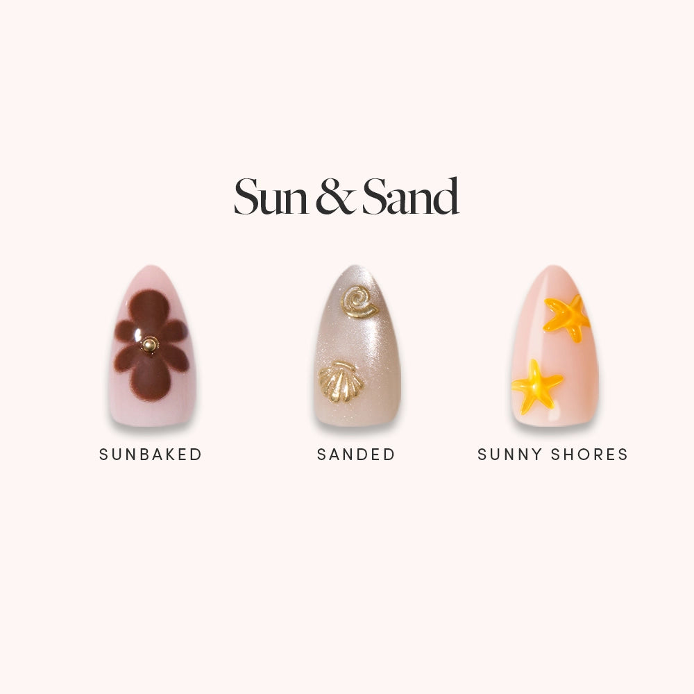 Glamnetic’s Sun & Sand set features three short almond press-on nails—Sunbaked (brown flower and gem), Sanded (gold seashells on beige), and Sunny Shores (yellow starfish on peach)—for a perfect tropical summer look. - Product image