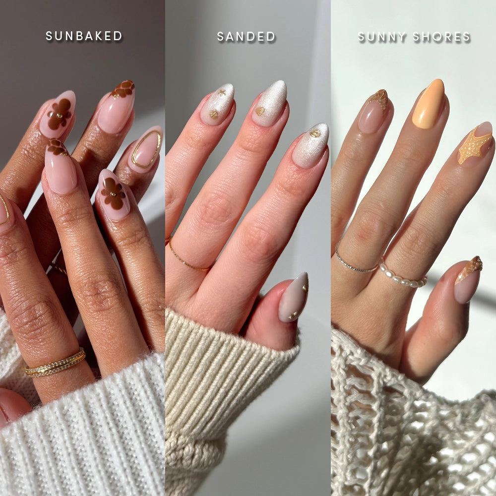 Three hands with manicured nails: left shows glossy pink and brown floral (Sun & Sand by glamnetic), center features nude and white with gold shimmer, right displays peach and gold nail art. - Product image