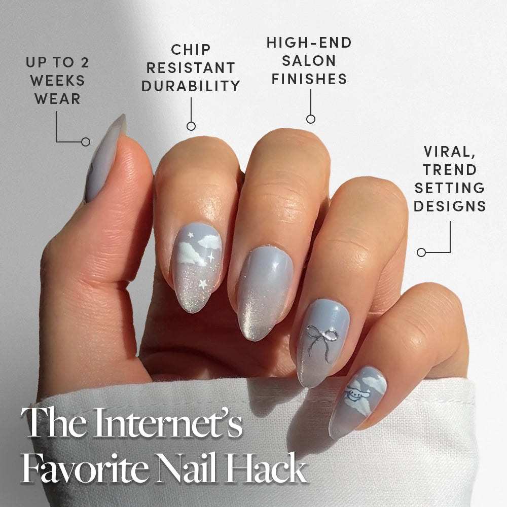 A hand with long, almond-shaped nails painted light blue with trendy white designs from the glamnetic Cinnamoroll™ Cloud set. Enjoy up to 2 weeks’ chip-resistant wear, salon-quality finish, and viral trendsetting style. - Product image