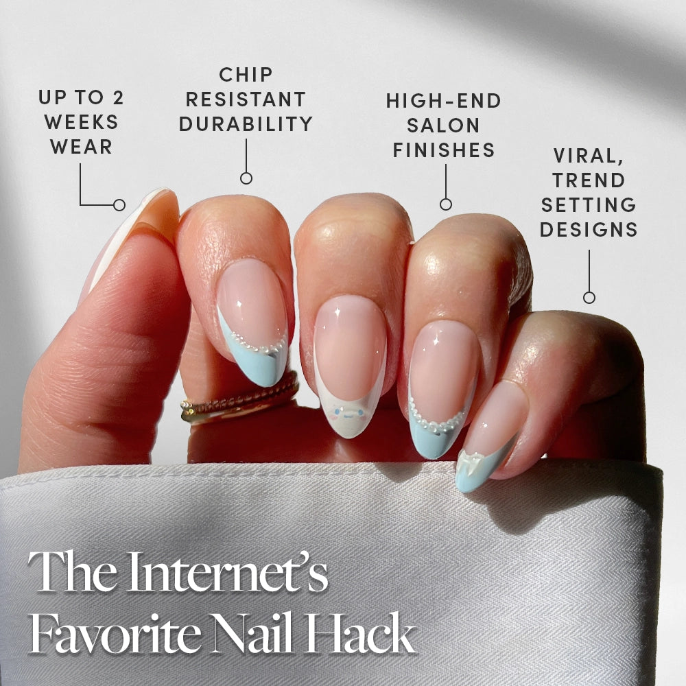 A hand with a pastel blue and white Cinnamoroll™ French Tip by glamnetic holds white fabric. Benefits: up to 2 weeks wear, chip-resistant, high-end finish, trendy almond press-ons. Caption: "The Internet’s Favorite Nail Hack. - Product image