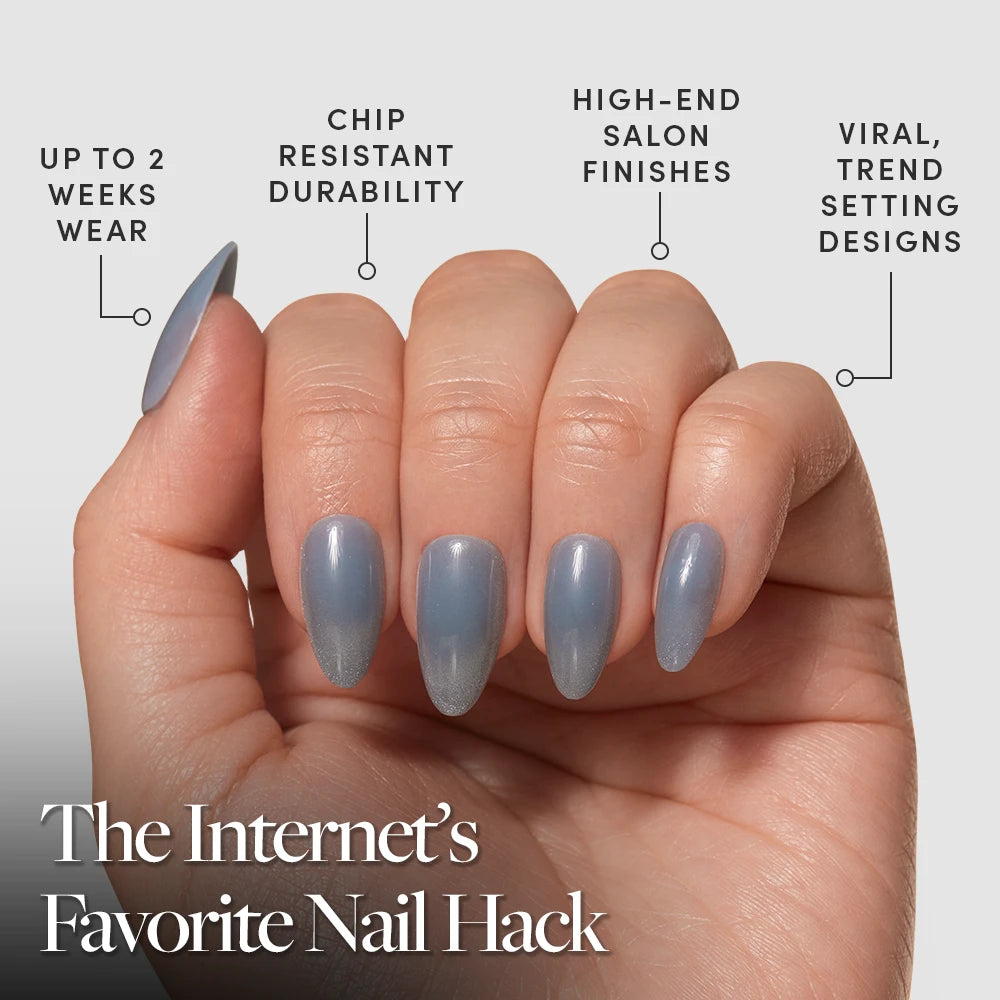 A hand with long, almond-shaped glamnetic Baby Blues press-on nails in shiny blue-gray. Benefits: up to 2 weeks wear, chip-resistant, high-end finishes, trendy designs. Text: The Internet’s Favorite Nail Hack. - Product image