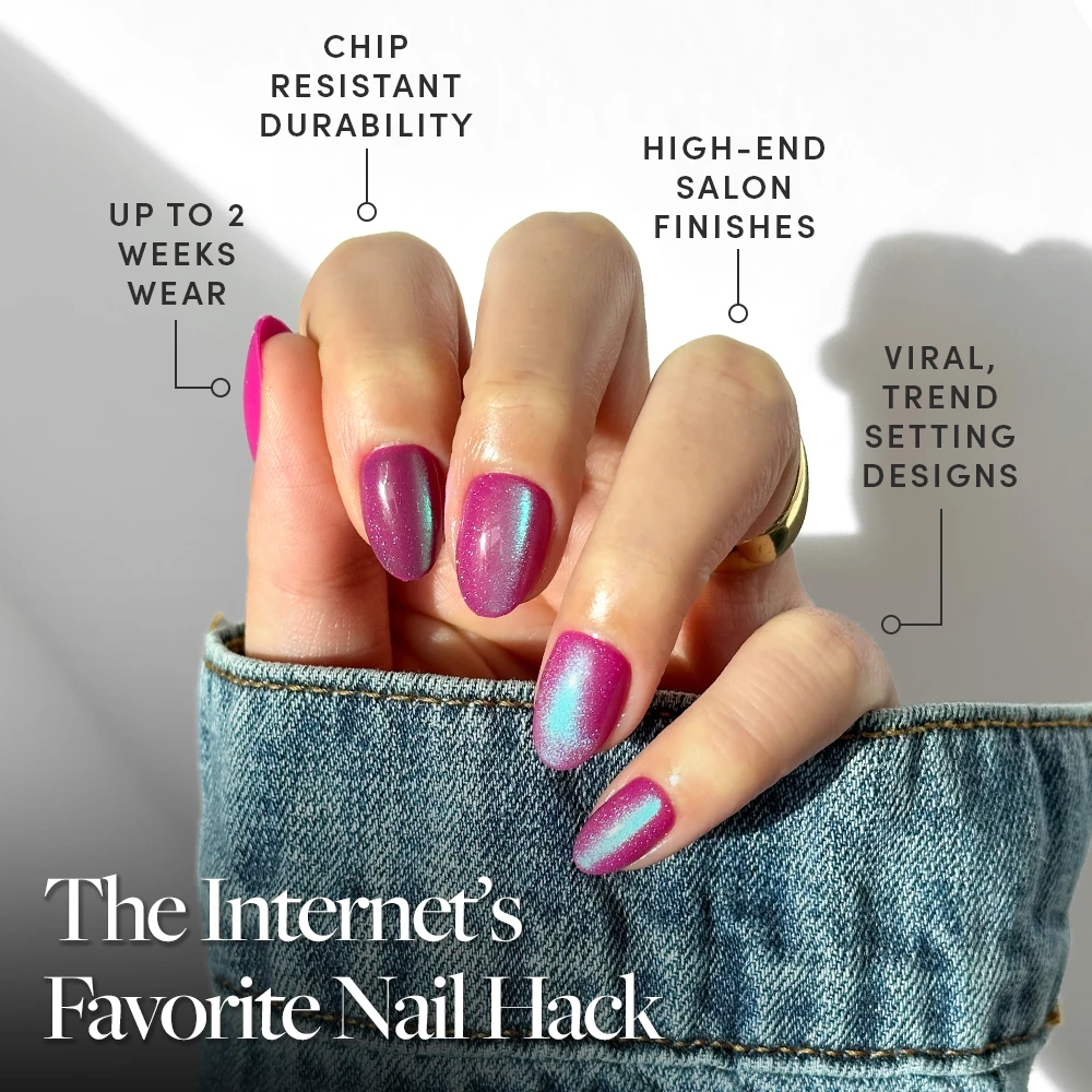 A hand with glamnetic's Berry Fizz press-on nails—featuring a shiny pink-purple velvet metallic finish—is shown in sunlight. Text highlights their chip-resistant durability, up to 2 weeks’ wear, luxe finish, and trendy design. Denim sleeve visible. - Product image