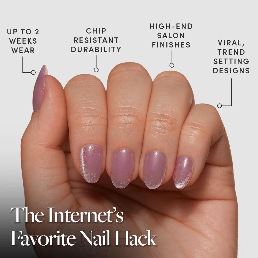 A hand with neatly manicured, iridescent short oval nails from glamnetic’s Fairy Dust set is shown. Enjoy up to 2 weeks wear, chip-resistant durability, salon-quality finish, and viral press-on nails—“The Internet’s Favorite Nail Hack.”. - Product image