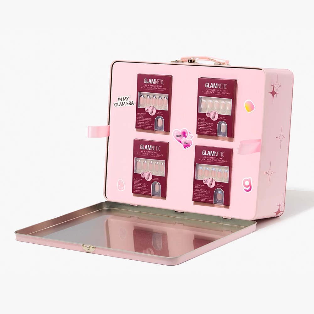 The glamnetic Quick Press Mani PR Box is a pink suitcase-style case with star designs and cute stickers, opening to reveal four boxed sets of no-glue press-on nails arranged inside the lid for a quick manicure anytime.