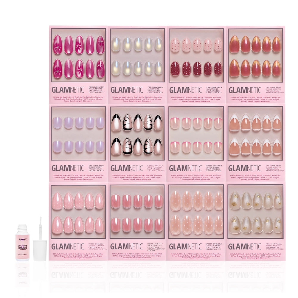 The Spring Edit Collection by glamnetic features twelve spring nail sets in assorted colors and shimmery designs, arranged in a grid with a pink bottle and applicator on the left. Each box highlights unique luminous nails, patterns, and shades. - Product image