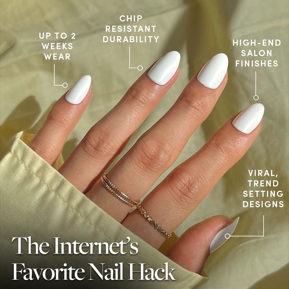 A hand with glamnetic Angel white press-on nails in a short almond shape is shown, featuring up to 2 weeks’ wear, chip resistance, luxe finish, and trendy design. Text: “The Internet’s Favorite Nail Hack.” Gold rings adorn the hand. - Product image