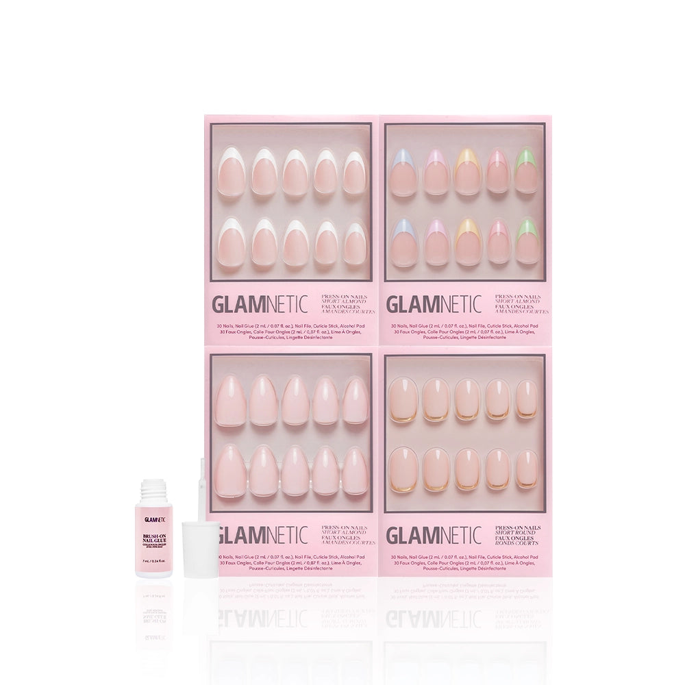 Four boxes of glamnetic Nail Obsessed French tip press-on nails in pink packaging are arranged in a square with a nail glue bottle in front, all placed against a white background. - Product image