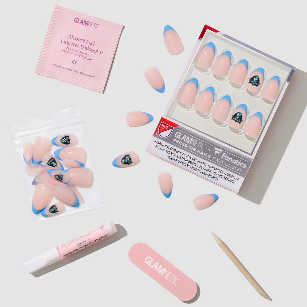 The glamnetic Philadelphia Union Press-On Nail Set features pink nails with blue tips and team logos, shown with a nail file, cuticle stick, nail glue, alcohol pad, and extra short almond nails on a white background. - Product image
