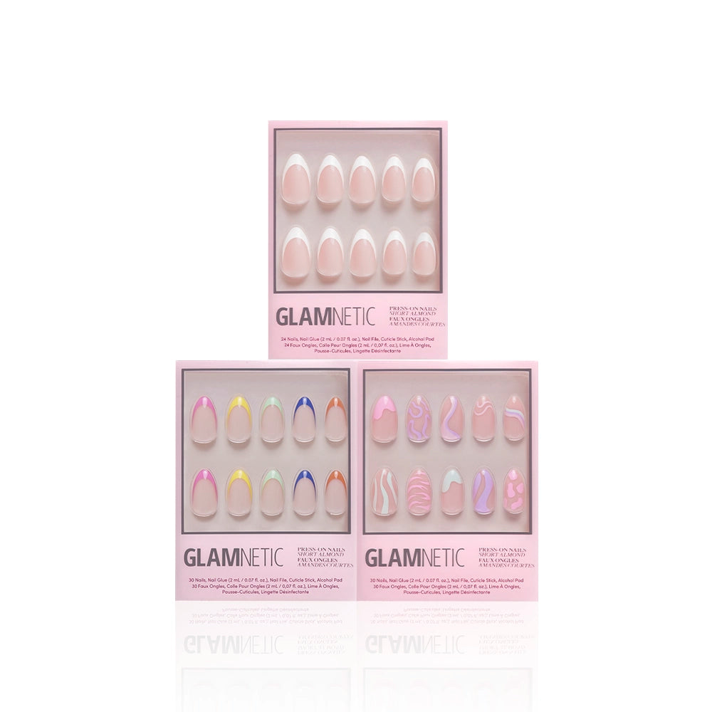 Three boxes of glamnetic's "The Favorite" press-on nails in pink packaging are shown, each featuring short almond nails with pastel designs: solid pink, french tip rainbow accents, and chic pink and white patterns. - Product image