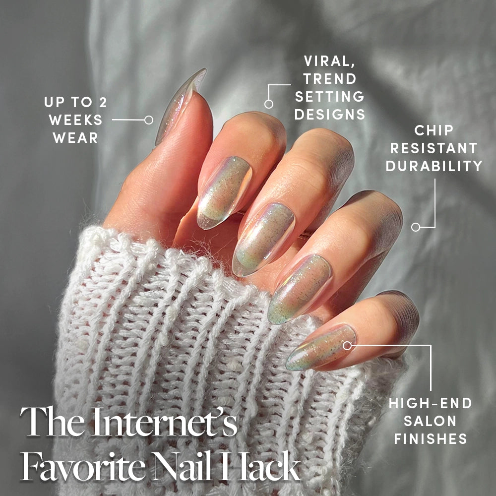 A hand with long, holographic almond nails (Stardust by glamnetic) is shown, featuring up to 2 weeks' wear, viral trend designs, chip-resistant durability, and high-end salon finishes. Caption: The Internet’s Favorite Press-On Nail Hack. - Product image