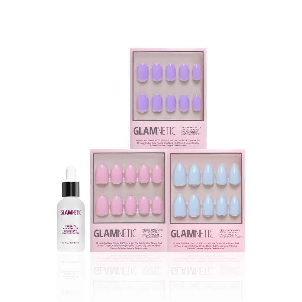 Three boxes of glamnetic Blooming Buds pastel press-on nails in lavender, pink, and blue are stacked in a triangle, with a glamnetic nail glue bottle with dropper cap positioned to the left. - Product image