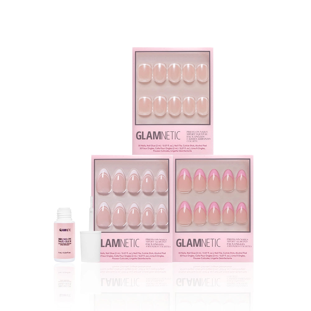 Three boxes of glamnetic French Tip Faves salon-quality press-on nails in assorted pink styles are arranged in a pyramid, with an open bottle of glamnetic nail glue to the left, all set against a white background. - Product image