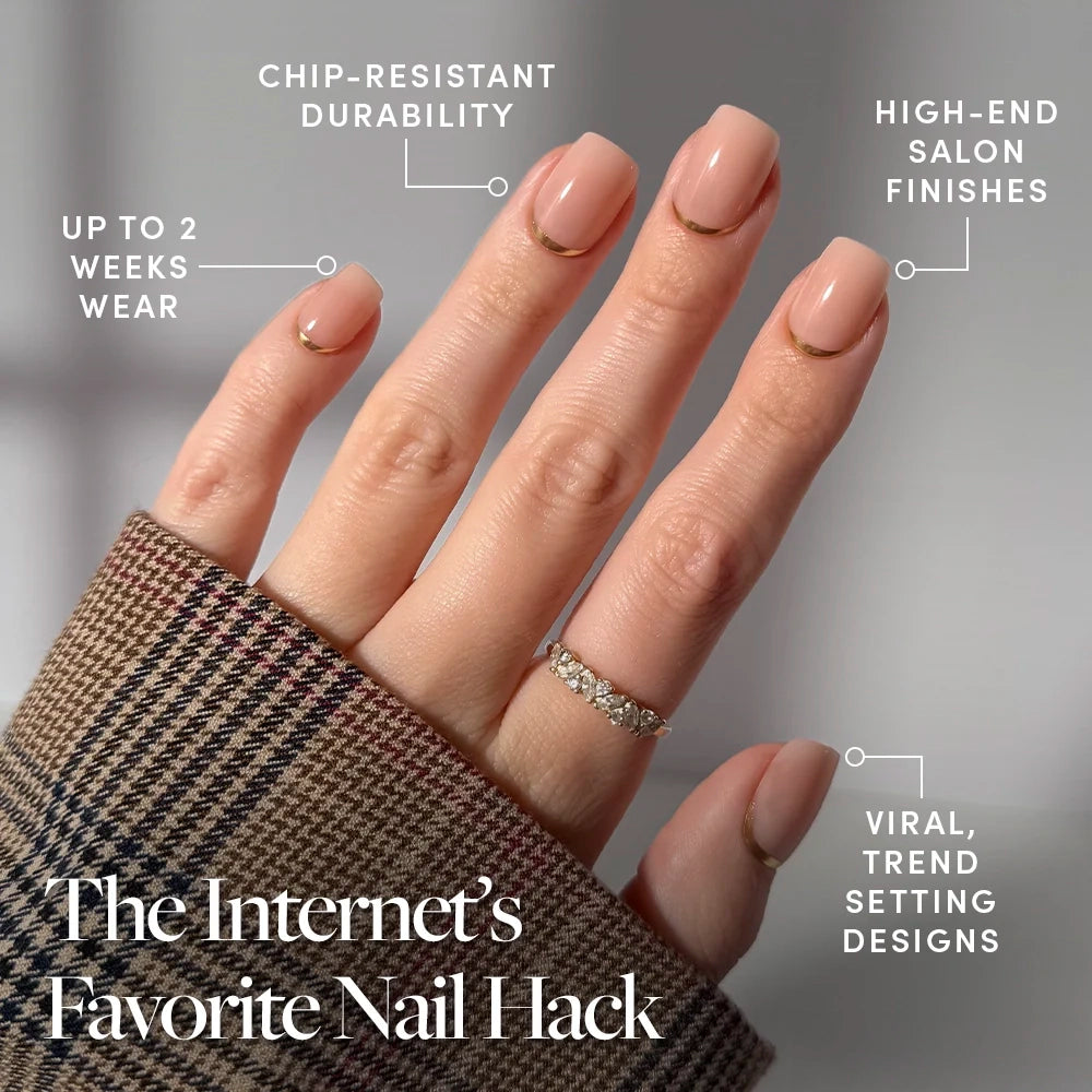 A hand with manicured short squoval nails in Goal Setter by glamnetic, a nude shade, wears a plaid sleeve and diamond ring. Features: chip-resistant, high-end finish, up to 2 weeks wear, and trendy design—this popular nail hack stands out. - Product image
