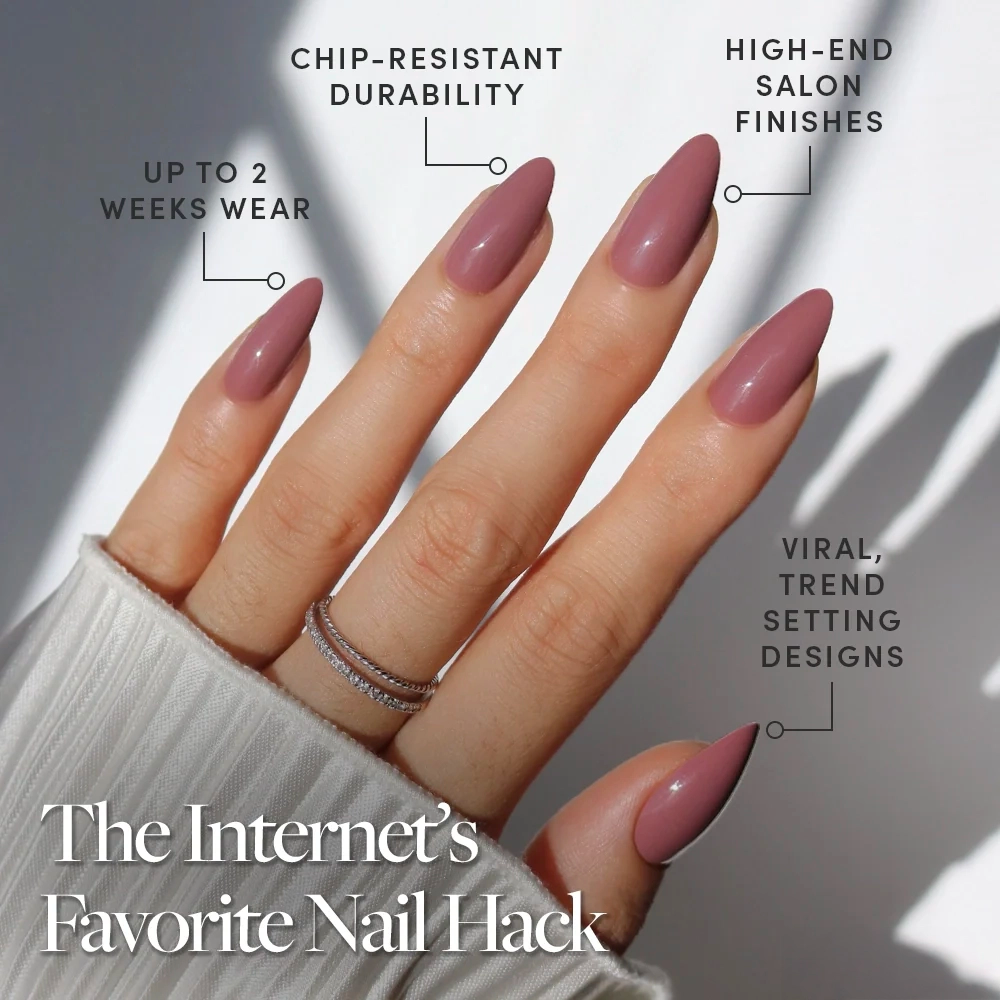 A hand with long, almond-shaped glamnetic Mauve Wife press-on nails is shown, featuring chip-resistant durability, two-week wear, salon-quality finish, and trendy designs. Text: The Internet's Favorite Nail Hack. - Product image