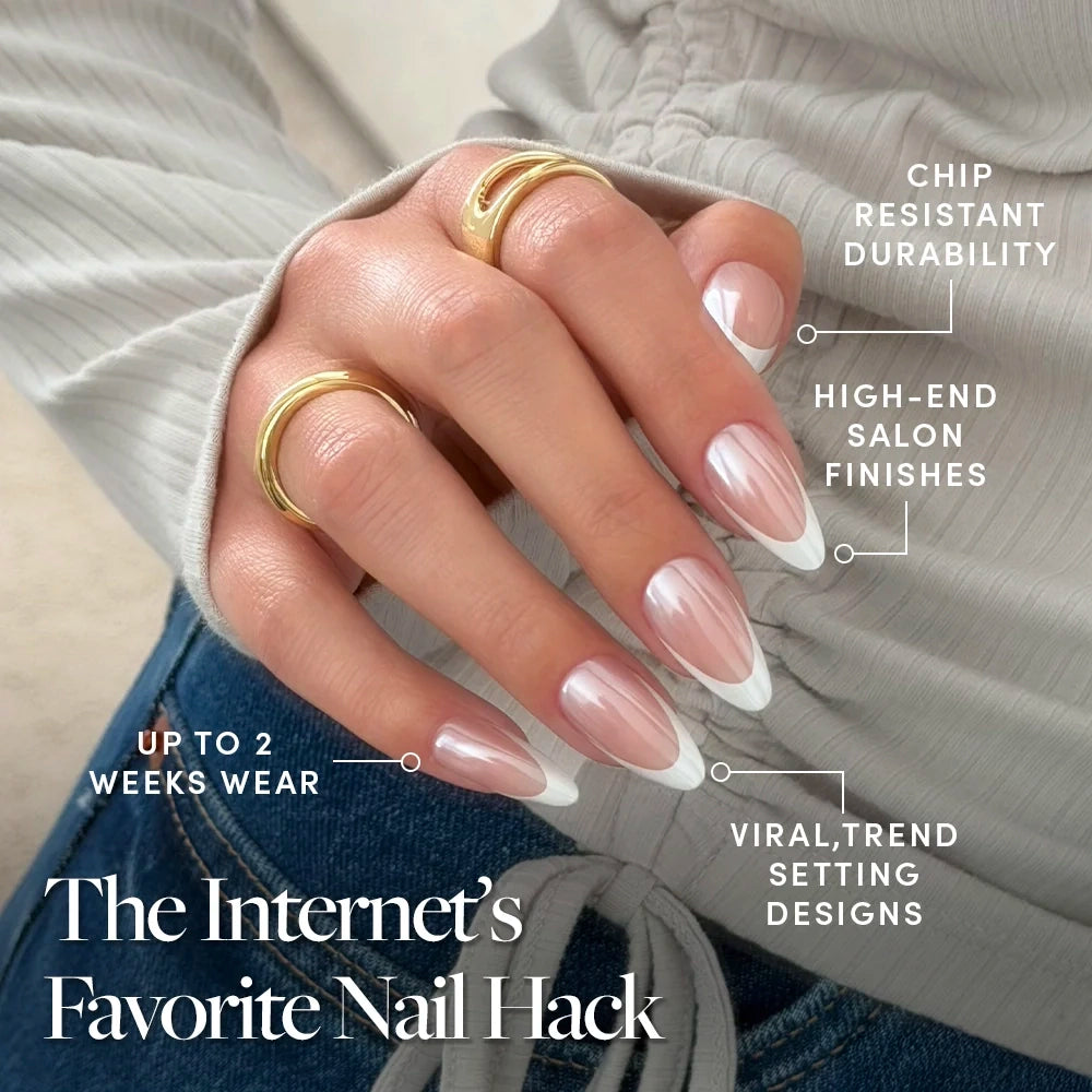 A hand wearing two gold rings displays glamnetic's Mother Pearl Press-On Nails in a long, almond French tip style—offering chip-resistant durability, salon-quality finishes, trendy designs, and up to 2 weeks of glossy glazed wear. - Product image