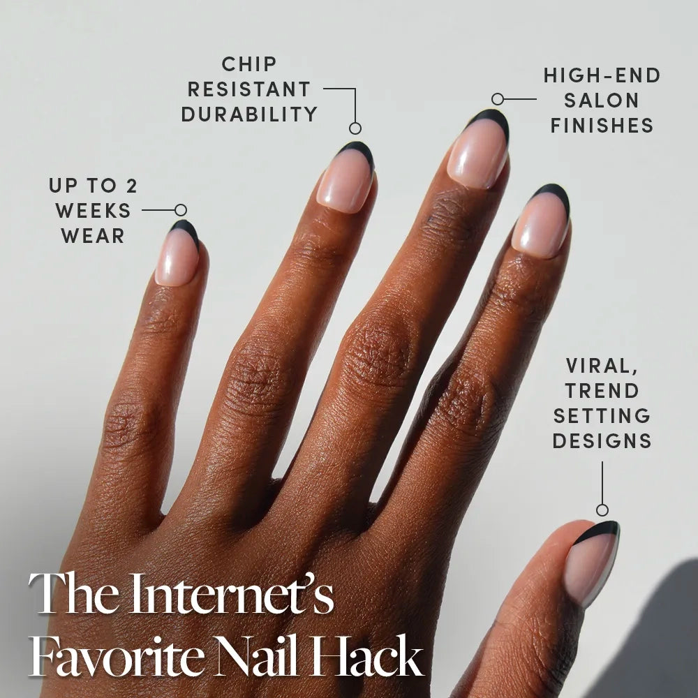 A hand with neatly manicured glamnetic Smoke Salt Press-On Nails showcases a modern black French tip. Benefits include up to 2 weeks wear, chip-resistant durability, salon-quality finish, and viral trend-setting style. - Product image