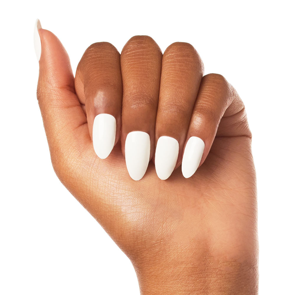 A hand with medium brown skin displays Angel by glamnetic—vegan, glossy white press-on nails in a chic almond shape. Fingers are slightly curled against a plain white background. - Product image