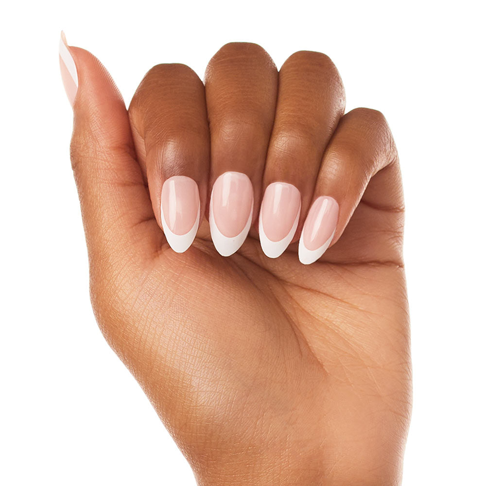 A hand with medium brown skin showcases glamnetics Ma Damn nails—neatly manicured, almond-shaped press-ons with a classic French tip design in white and pale pink—set against a white background. - Product image