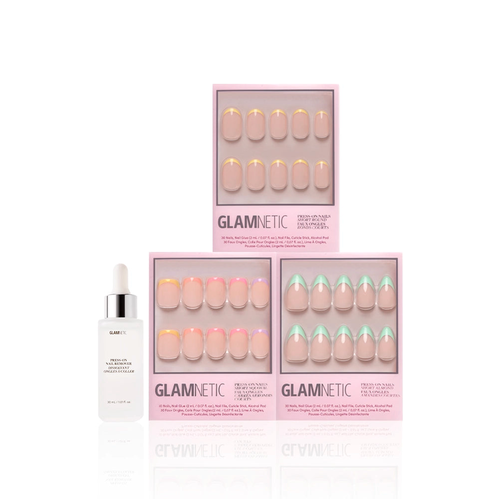 Three boxes of glamnetic À La Ann press-on nails in various pastel French tip designs are stacked beside a white serum bottle with a dropper, all arranged against a clean white background. - Product image