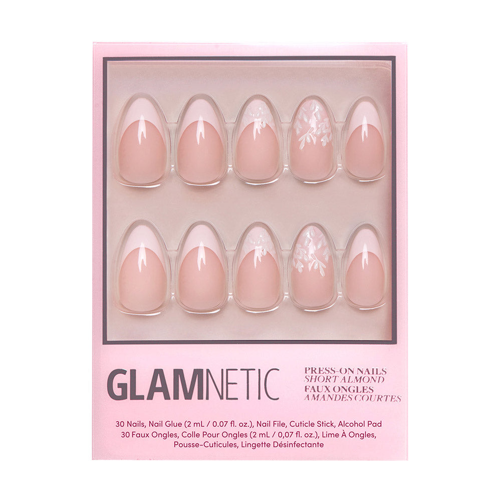 A box of glamnetic All Time Love short almond nails in pink, with white floral designs and subtle French tips. Packaged in pink with product details at the bottom. All nails are vegan and cruelty-free. - Product image