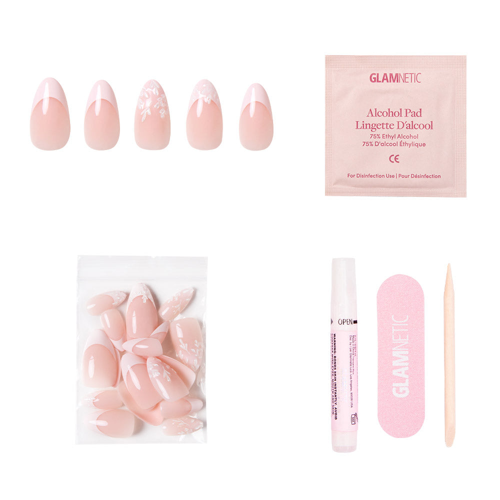 The glamnetic All Time Love set features vegan, cruelty-free pink press-on nails with floral designs and French tips, plus an alcohol pad, extra nails, nail glue, a pink file, and a cuticle stick—all on a white background. - Product image